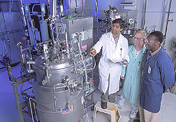 Chemist discusses control parameters of mannitol production with technician and student aide: Click here for full photo caption.