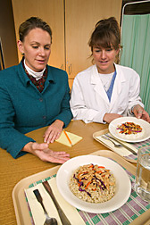 Principal dietitian and doctoral student review the dinners for the diet study: Click here for full photo caption.