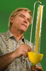 Retired chemist examines a Flybrella trap: Click here for full photo caption.