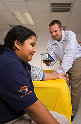 A nutrition instructor at Baylor College of Medicine assesses the blood pressure of a study volunteer: Click here for full photo caption.