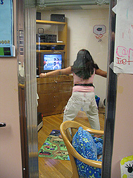 Young volunteer in a room-size calorimeter, where the calories she uses can be monitored: Click here for full photo caption.