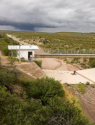 In the Walnut Gulch Experimental Watershed near Tombstone, Arizona, hydraulic technicians prepare flume number 6 for monitoring the next flow event to determine runoff from a portion of the watershed: Click here for photo caption.