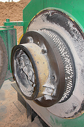 A die extrudes pellets at the pellet mill of Plainview Growers in Allamuchy, New Jersey, as a feedstock for heating greenhouses: Click here for photo caption.