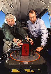 A physical scientist adjusts an airborne hyperspectral sensor. Click here for full photo caption.