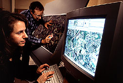 Sara Loechel, a remote sensing researcher, labels fields, woodlands, and streams on a computer. Click here for full photo caption.