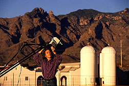 To obtain views of the soil surface from various angles, a soil scientist uses a specially mounted radiometer. Click here for full photo caption.