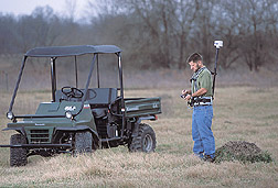 Technician uses a GPS unit to record the exact position of a fire ant mound: Click here for full photo caption.