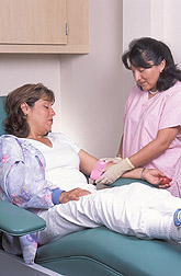 Registered nurse completes a blood draw on a study participant: Click here for full photo caption.