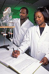 Chemist and technician process water samples: Click here for full photo caption.