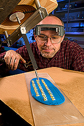 Technician injects virus into corn kernels: Click here for full photo caption.