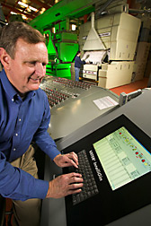 Agricultural engineer inputs control data into a computerized process control system: Click here for full photo caption.