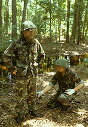 In 1984, ARS technicians Kenneth Posey (left) and Dick Godwin conduct a Florida field test of mosquito repellents on skin and in military uniforms: Click here for photo caption.