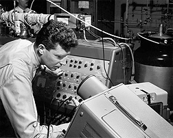 WRRC scientist Bill McFadden operates the mass spectrometer portion of the gas chromatography/mass spectroscopy apparatus first reported at WRRC. (1963): Click here for photo caption.