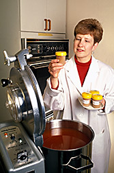 Nutritionist Joanne Holden looks over tomato products prepared for a study of carotenoids. Click here for full photo caption.
