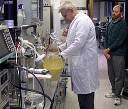 Microbiologist observes Russian scientist harvesting bacteriocins: Click here for full photo caption.