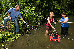 ARS soil scientist, University of Maryland support scientist (center), and ARS chemist use an Acoustic Doppler Channel Profiler to assess water velocity and channel geometry of a Choptank Watershed stream: Click here for full photo caption.