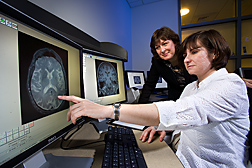 Nutritional epidemiologist (left) and neuropsychologist examine MRI (magnetic resonance imaging) brain scans to determine size and area of damage that may affect cognitive functions: Click here for full photo caption.