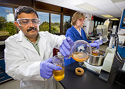 Former ARS chemist (left) and technician purify glycerol, a biodiesel coproduct that can be used to produce value-added materials: Click here for full photo caption.