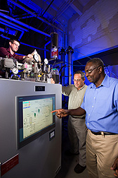 At Wyndmoor, Pennsylvania, chemical engineer Akwasi Boateng (right) and mechanical engineer Neil Goldberg (center) adjust pyrolysis conditions while chemist Charles Mullen loads the reactor with bioenergy feedstock: Click here for photo caption.
