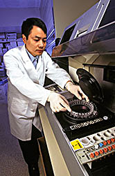 Guohua Cao loads extracts of fruit and vegetable samples onto an automated centrifugal analyzer.