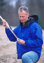 Soil scientist collects a soil sample: Click here for full photo caption.