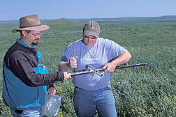 Research associate and ARS physical science technician take soil samples from rangeland: Click here for full photo caption.