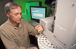 Technician analyzes water samples collected from surface runoff and groundwater springs: Click here for full photo caption.
