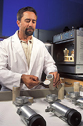 Technician prepares particulate-filter samples: Click here for full photo caption.