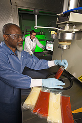 Food microbiologist and engineer evaluate effects of high-pressure processing on microbial stability of tomato juice and liquid eggs: Click here for full photo caption.