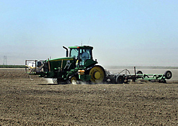 A tractor is used to inject Telone II into the soil at a depth of 46 inches. Following the tractor is a disk and ring roller—used to compact the soil and close any fractures, thus reducing emissions to the atmosphere: Click here for photo caption.