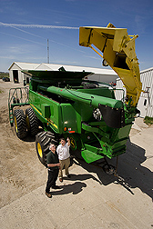 Soil scientist (left) discusses commercial combine modifications: Click here for full photo caption.