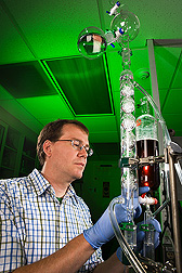 Chemist performs a lab-scale distillation of ethanol from a fermentation broth: Click here for full photo caption.