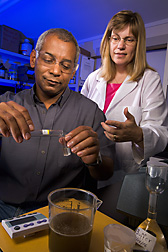 Chemist (right) demonstrates the simple, rapid enzymatic mannitol test to a factory laboratory technician at Alma Sugarcane Factory, Lakeland, Louisiana: Click here for full photo caption.