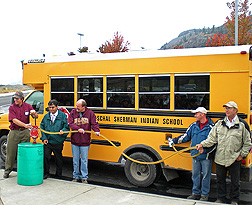 A biodiesel blend containing oil from winter canola is pumped into a Paschal Sherman Indian School bus: Click here for full photo caption.