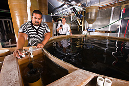 ARS engineering technician (left) and director of aquaculture systems research at the Freshwater Institute collect water from a tank used to study Atlantic salmon growth and test the sample for dissolved oxygen concentration: Click here for full photo caption.