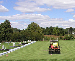 Pesticides being applied to experimental turf plots maintained at a golf course fairway: Click here for full photo caption.