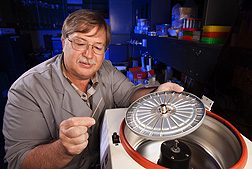 Technician Mike Judy loads immunoglobulin immunocrit tubes into a centrifuge: Click here for full photo caption.