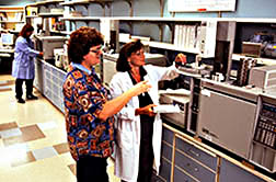 Technicians Kathryn Morford (left foreground) and Ronah Grigg analyze extracts of crops grown on IR-4 test plots