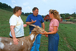 ARS chemist and animal scientist talk with producer Debbie Lehman about economical ways to meet the nutritional needs of goats.