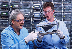 Virologist and food scientist examine mice used in studies: Click here for full photo caption.