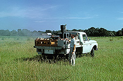ARS researcher operates experimental truck-mounted ultra-low-volume equipment: Click here for full photo caption.