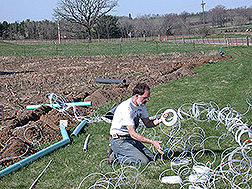 Soil scientist installs drainage lysimeters: Click here for full photo caption.