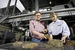At the University of Minnesota-Morris Biomass Gasification Facility, gasification researcher and ARS soil scientist evaluate potential biomass feedstocks, including pressed corn stover for use in an institutional-scale unit: Click here for full photo caption.