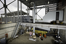 At the University of Minnesota-Morris Biomass Gasification Facility, gasification researcher and ARS soil scientist evaluate potential biomass feedstocks: Click here for full photo caption.