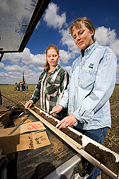 Soil scientist (right) and technician separate the samples by depth before lab analysis for carbon, nitrogen, and other nutrients: Click here for full photo caption.