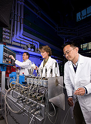 ARS chemist (left) works with collaborators of Lapol, LLC, to improve the heat tolerance of environmentally friendly plastic made from corn: Click here for full photo caption.