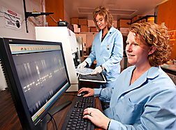 Geneticist (right) and technician use a gel imager to evaluate genotypes of Red Angus cattle for osteopetrosis phenotypes: Click here for full photo caption.