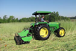 In an experiment at Randle Farms near Auburn, Alabama, technician Corey Kichler operates a two-stage roller/crimper that has a primary drum and a spring-loaded secondary drum with attached equally spaced crimping bars: Click here for photo caption.