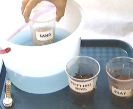 Image of sand sample bing placed in water pail