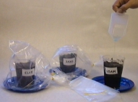 image of experiment setup with bags over clay and sand. Shoot has appeared on loam sample and bag is being removed.